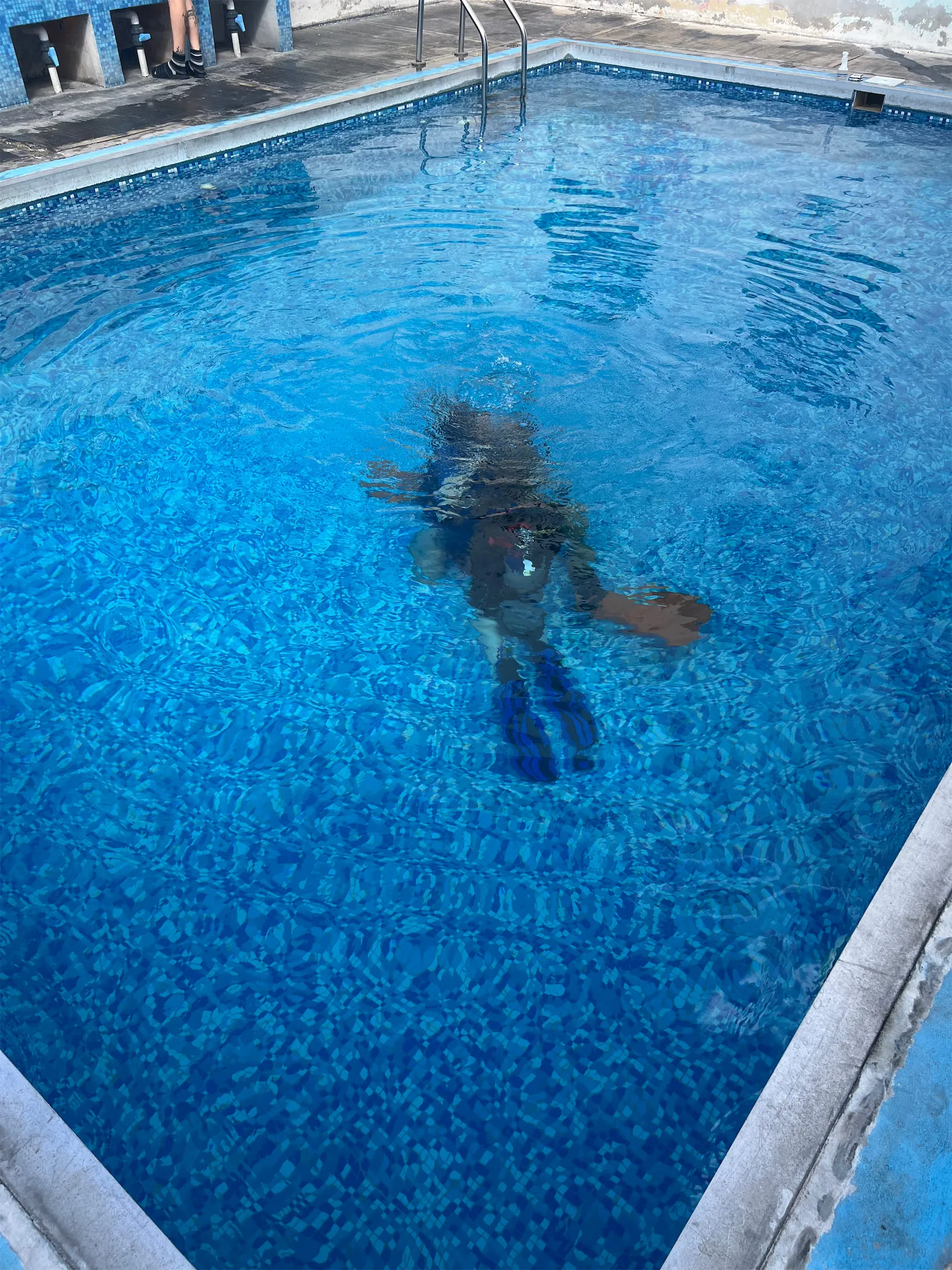 Practicing scuba skills in the dive school pool before the open-water dive