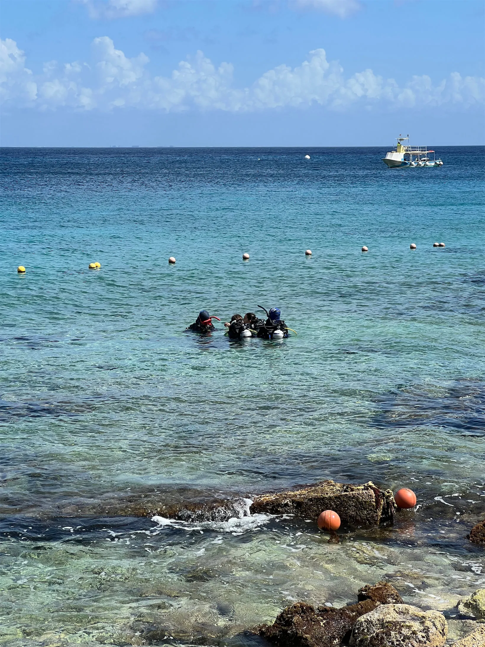 Divers in shallow water during a shore session at Tikila Beach, Cozumel