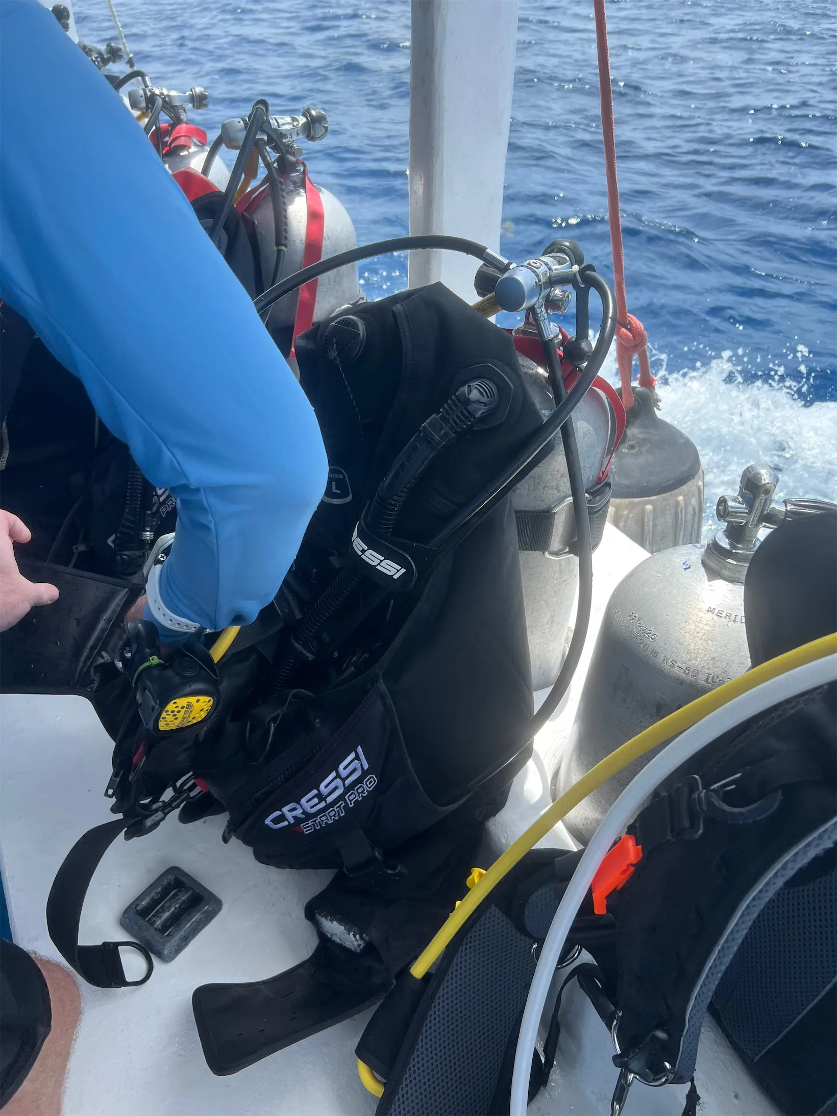 Instructor prepping a beginner's gear on the dive boat off Cozumel